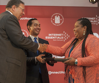 David L. Cohen of Comcast, left, and HUD Sec. Julian Castro are pictured with Karisha Bailey.
