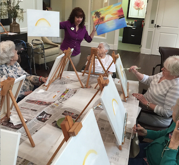 Bonnie Parton leads a painting class for residents at Dominion Senior Living of Johnson City.