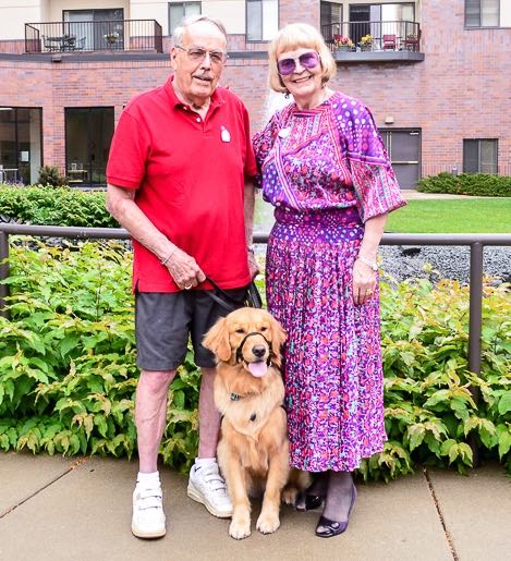 Alta the service dog with Covenant residents Emery and Rubye Erickson.
