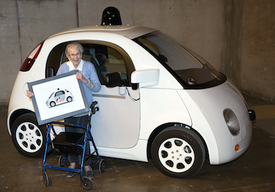 Florence Swanson poses with a framed version of her design in front of a Google car.