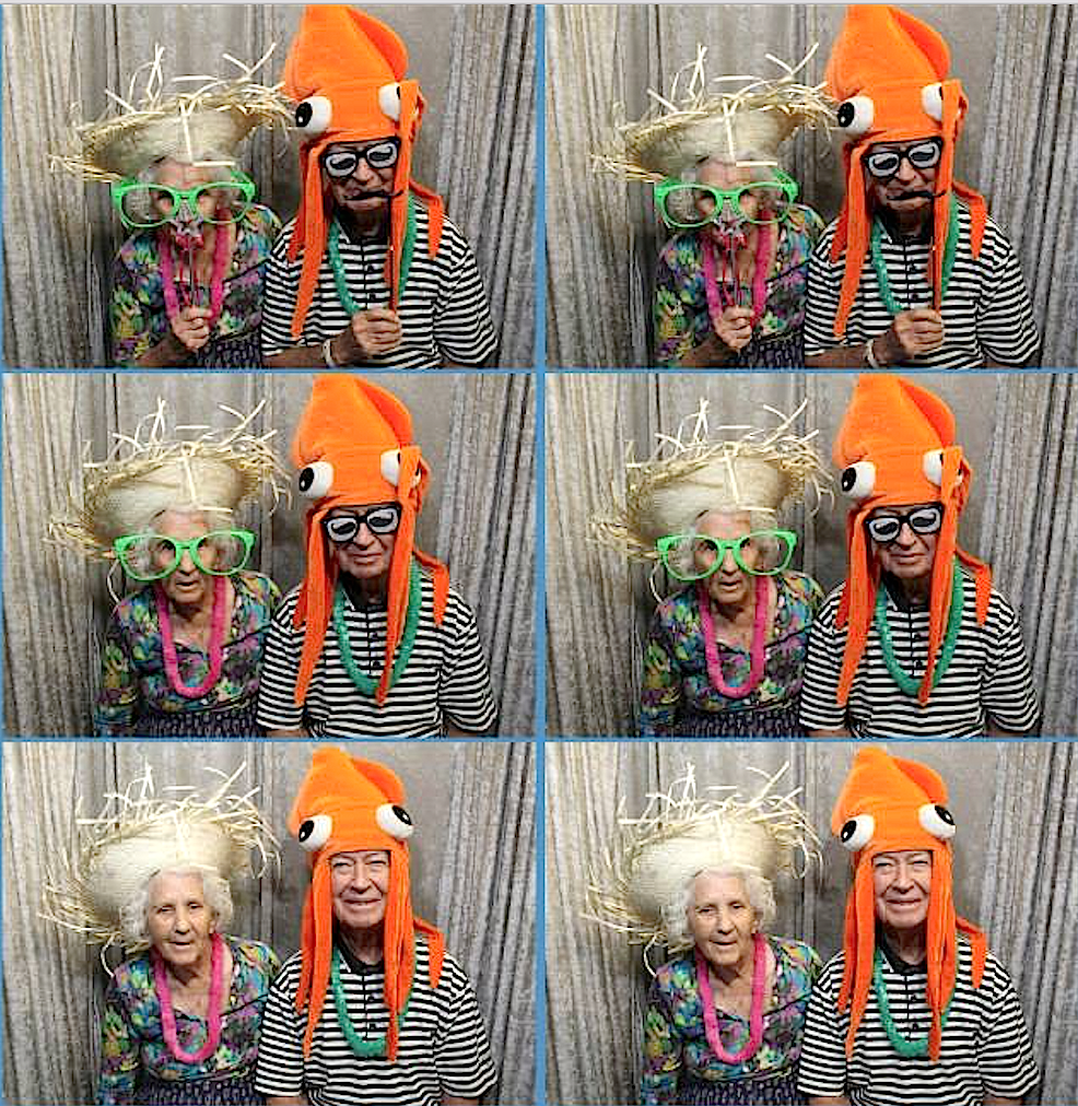 Tallgrass Creek residents enjoy the photo booth at the community's recent luau.