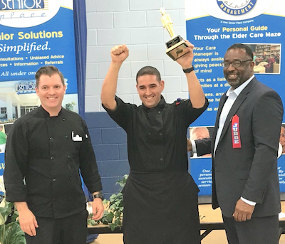 Manny Navarro hoists his trophy after winning the chef's competition.