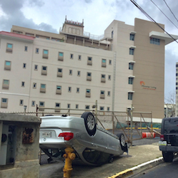 An overturned car rests on its roof outside Miramar Living after Hurricane Maria.