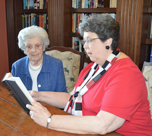 Parkway Place resident Barbara McNeir, right, reads aloud to fellow resident Betty Bryant.