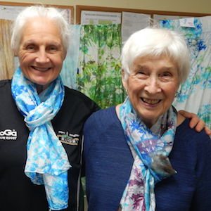 Residence at Otter Creek residents model the silk scarves they made.