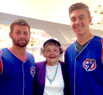 Craig Brooks, left, and Carson Sands of the South Bend Cubs flank a St. Paul's resident.
