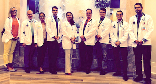 Mariana Dangiolo, M.D., center, poses with UCF medical students at Watercrest of Lake Nona.
