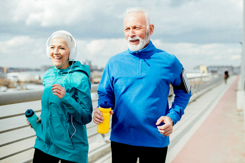 Older couple listening music and running
