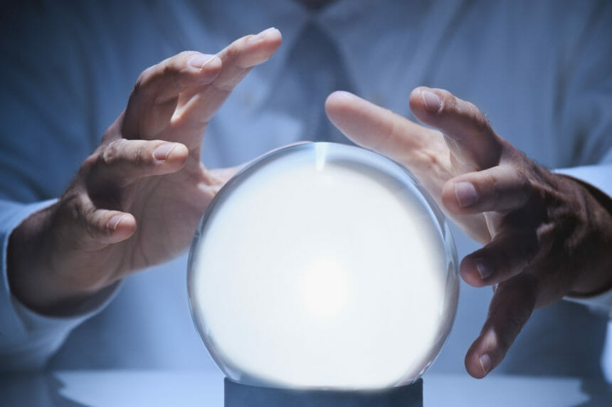 businessman with hands above crystal ball