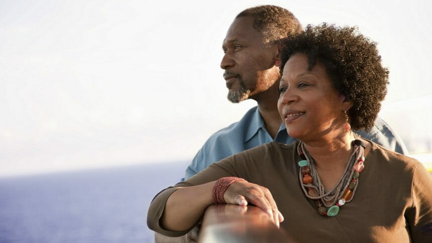 Mature African American couple on deck of a cruise ship, looking out into the ocean