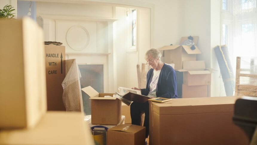 senior woman looks through some memories just before the house move begins