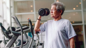 Asian man lifting weight in exercise room