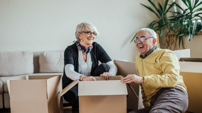 Senior couple unpacking cardboard boxes