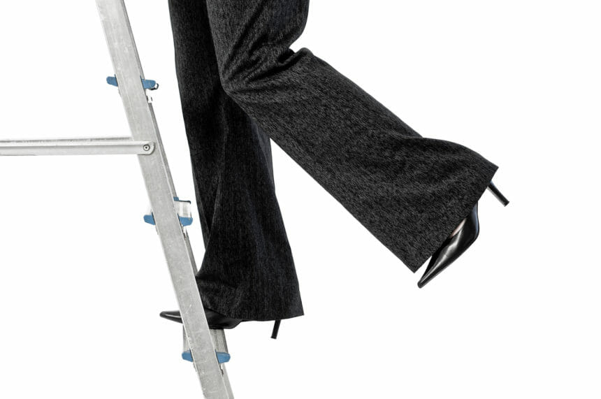 Business woman on step ladder on white
