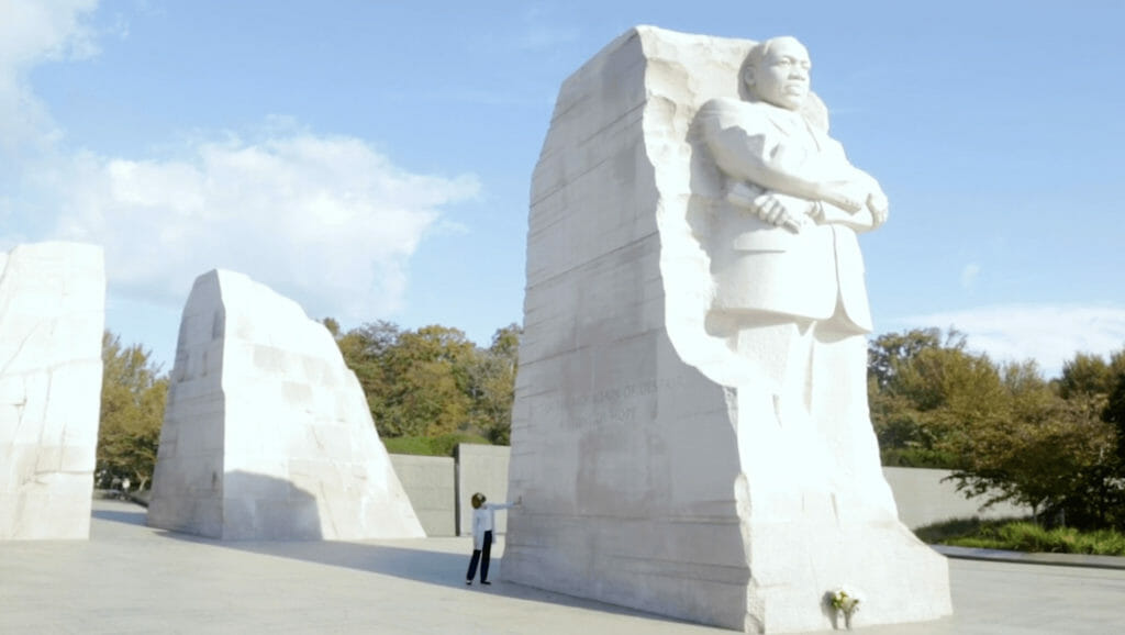 woman touches Martin Luther King Jr. Memorial