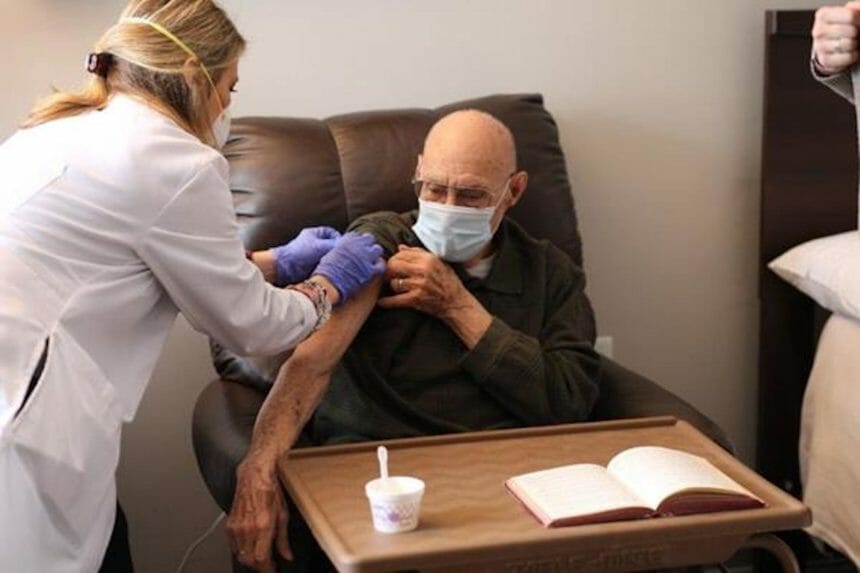 senior living resident gets vaccinated against COVID-19
