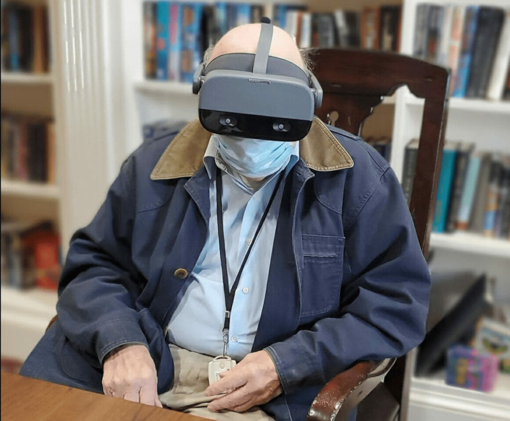 Senior living resident using REACT Neuro cognitive test device.