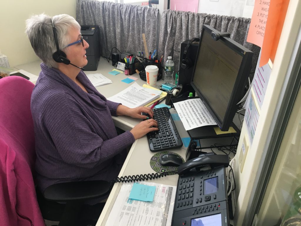 woman at Aroostook Agency on Aging works at her desk