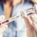 COVID vaccine in hands of caregiver