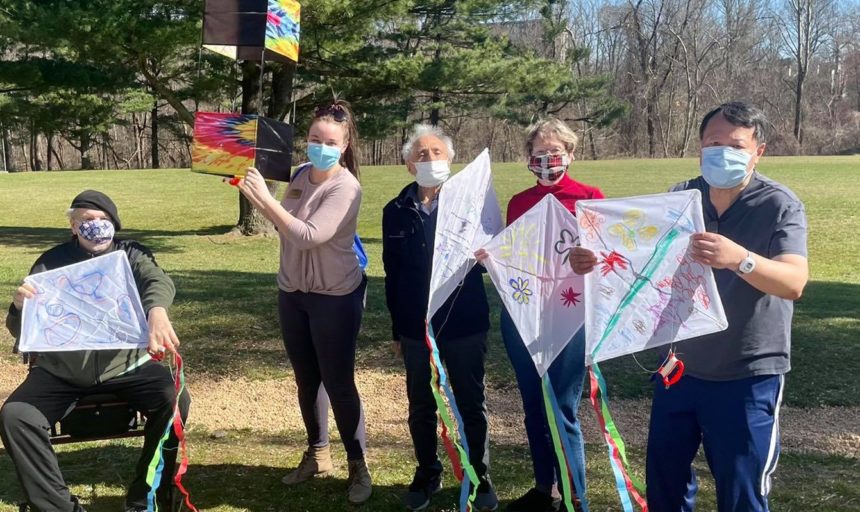 older adults and caregivers flying kites
