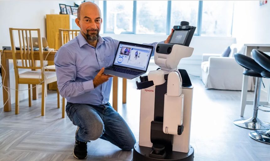researcher kneeling next to robot
