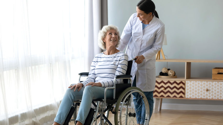 Caregiver pushing resident in a wheelchair