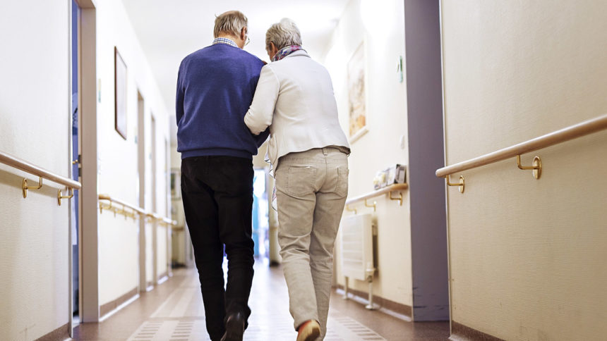 Senior couple walking down a hallway