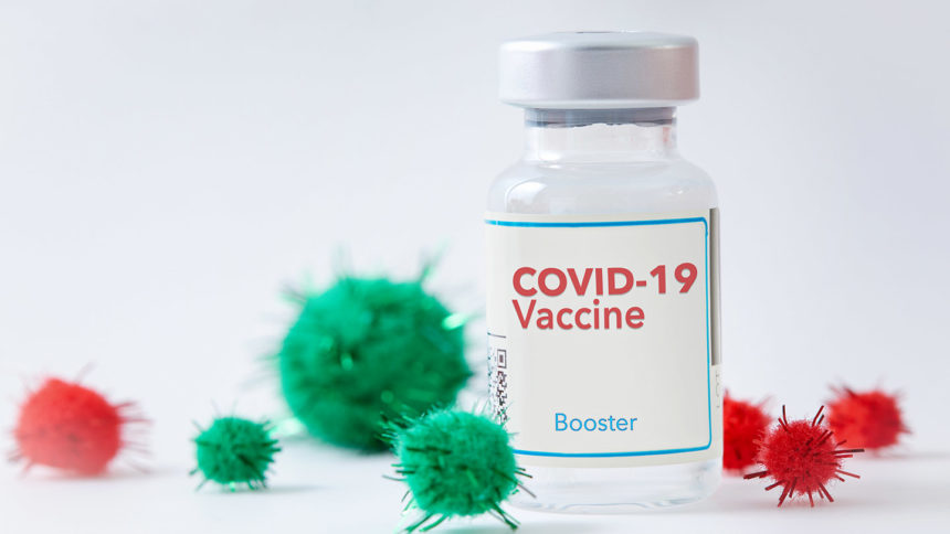 A vial of coronavirus vaccine with Christmas decoration resembling the virus.