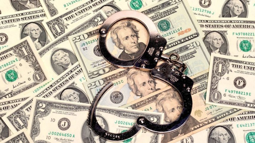 Handcuffs lying on a pile of money