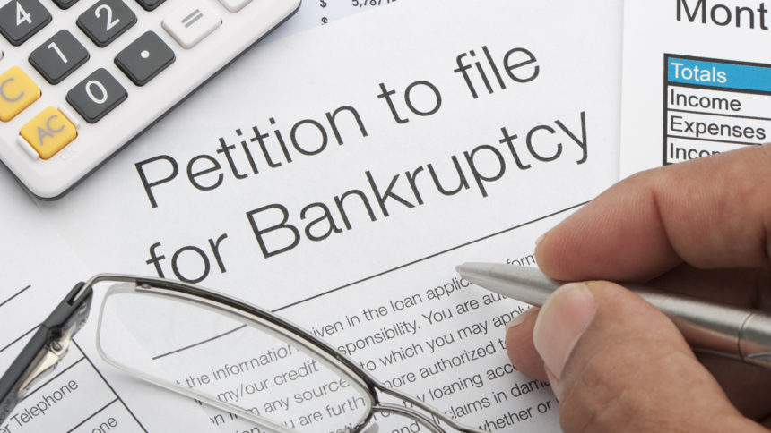 closeup of someone filing out a bankruptcy petition