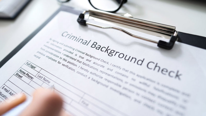 clipboard with criminal background check paperwork