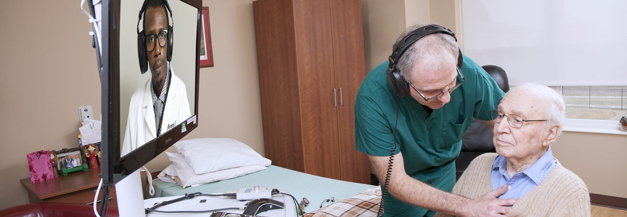 Senior living resident attending a telemedicine appointment in his room.
