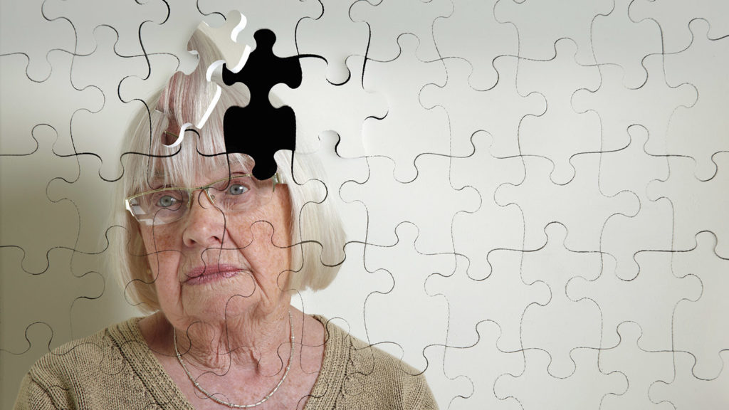 Jigsaw puzzle, of a senior woman, falling apart
