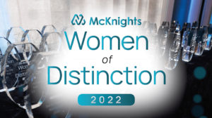 McKnight's Women of Distinction logo in front of table of awards