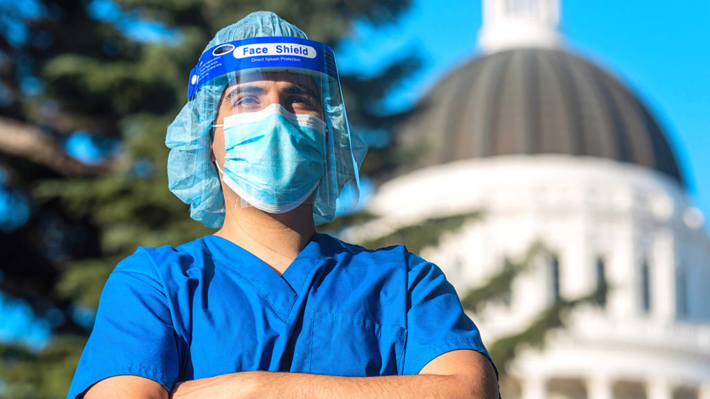 Healthcare worker standing in front of a capitol building