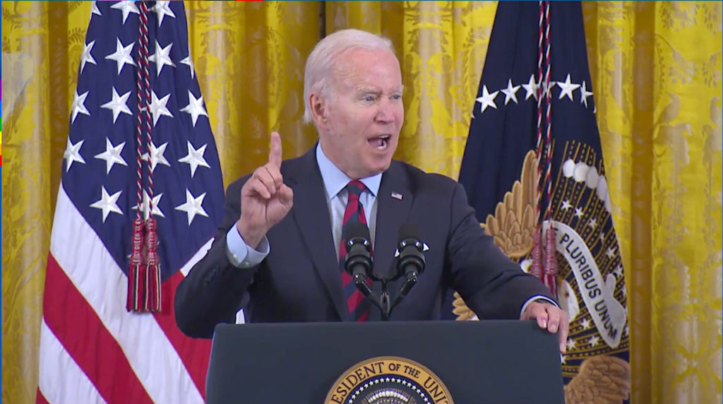 President Joe Biden speaking at podium