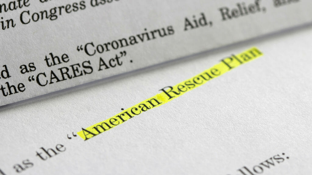 Closeup of the documents of both the Cares Act (Coronavirus Aid, Relief, and Economic Security Act) and the American Rescue Plan Act (ARPA) of 2021. A comparison between two acts.