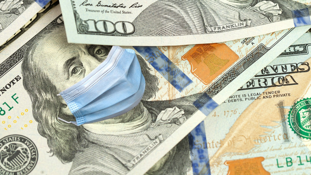 COVID-19 coronavirus in USA, 100 dollar money bill with Franklin in surgical face mask, macro. COVID affects global stock market.