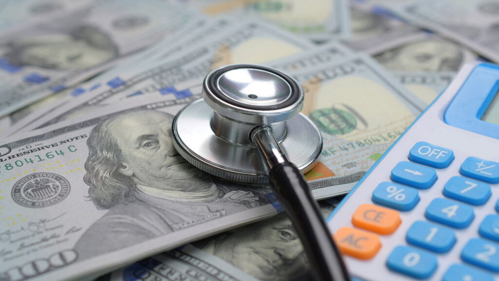 Healthcare payment concept with stethoscope and big money US dollar.
