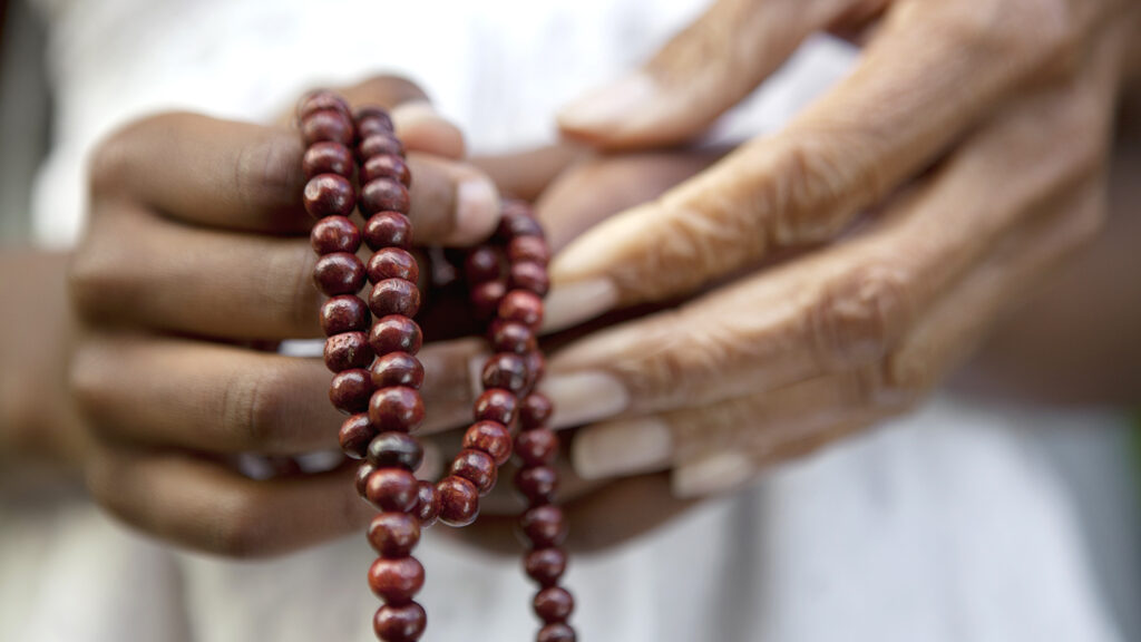 Close up of hands holding beads