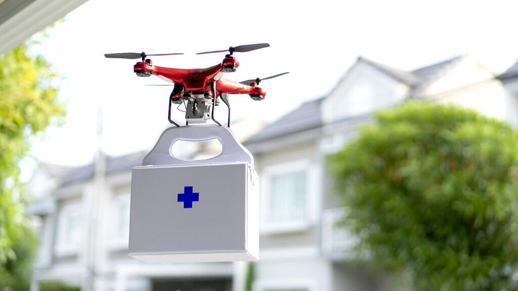Drone quadcopter carrying first aid kit.