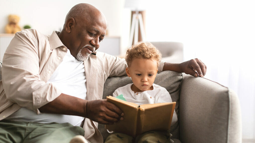 Man with child reading a book
