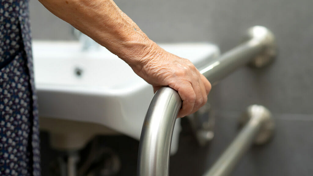 Asian senior or elderly old lady woman patient use toilet bathroom handle security in nursing hospital ward