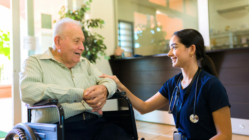 Happy retired man chatting with a beautiful latin nurse
