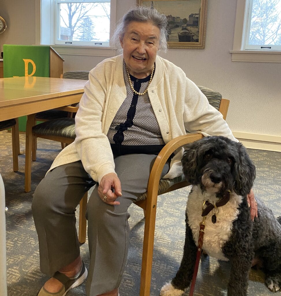 A senior living resident and a dog