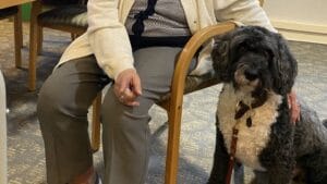 Close-up of a senior living resident and a dog.