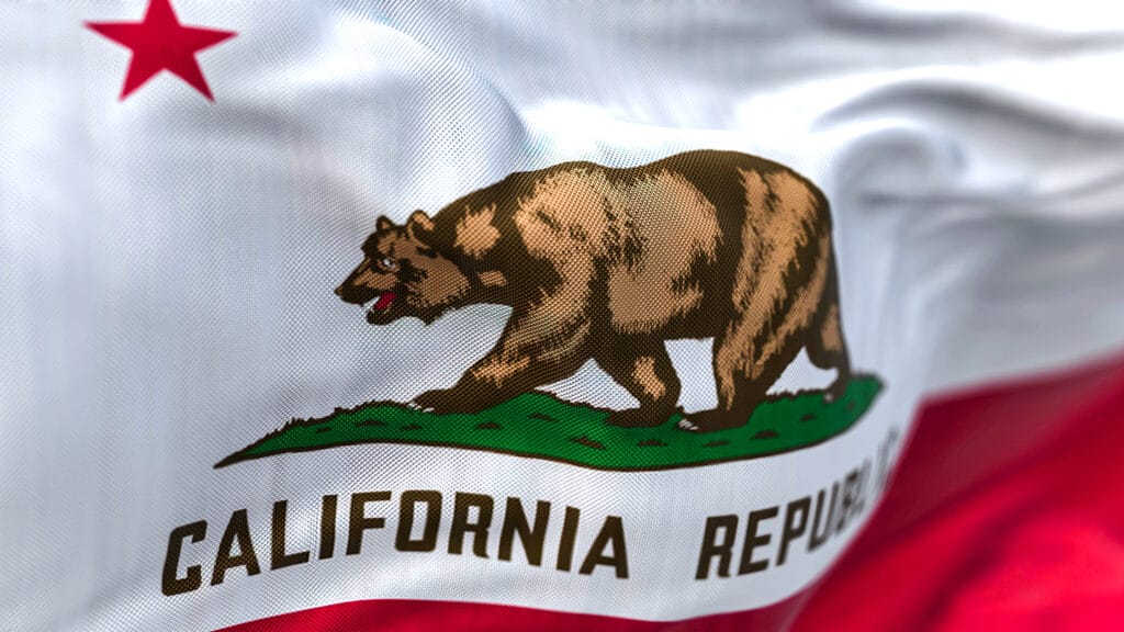 Close-up view of the California State flag waving. California flag is also the Bear Flag. Rippled Fabric. Textured background. Selective focus. Realistic 3d illustration